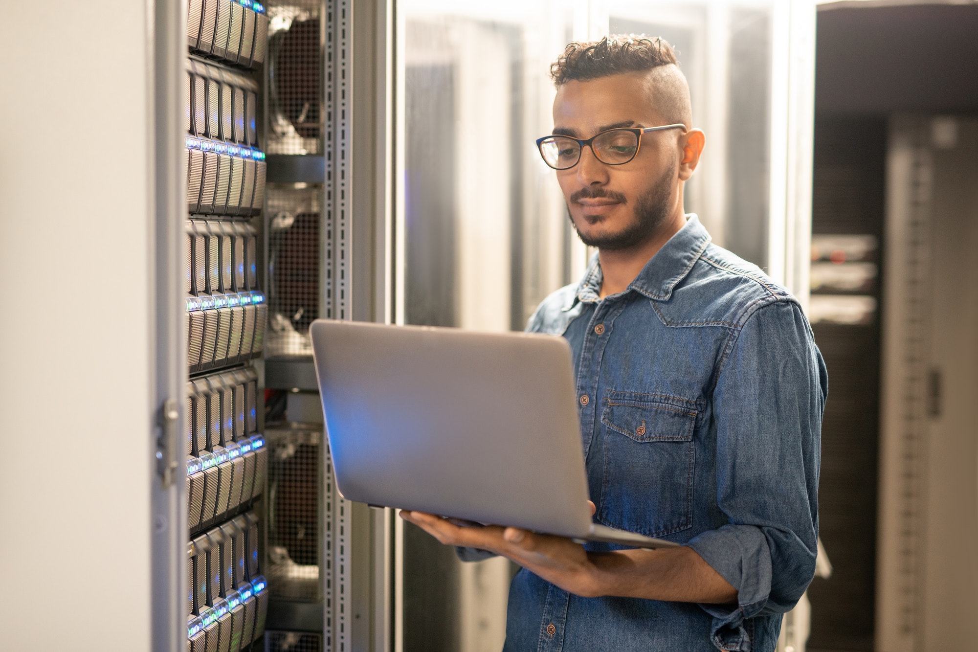 Arabian IT specialist monitoring network processes