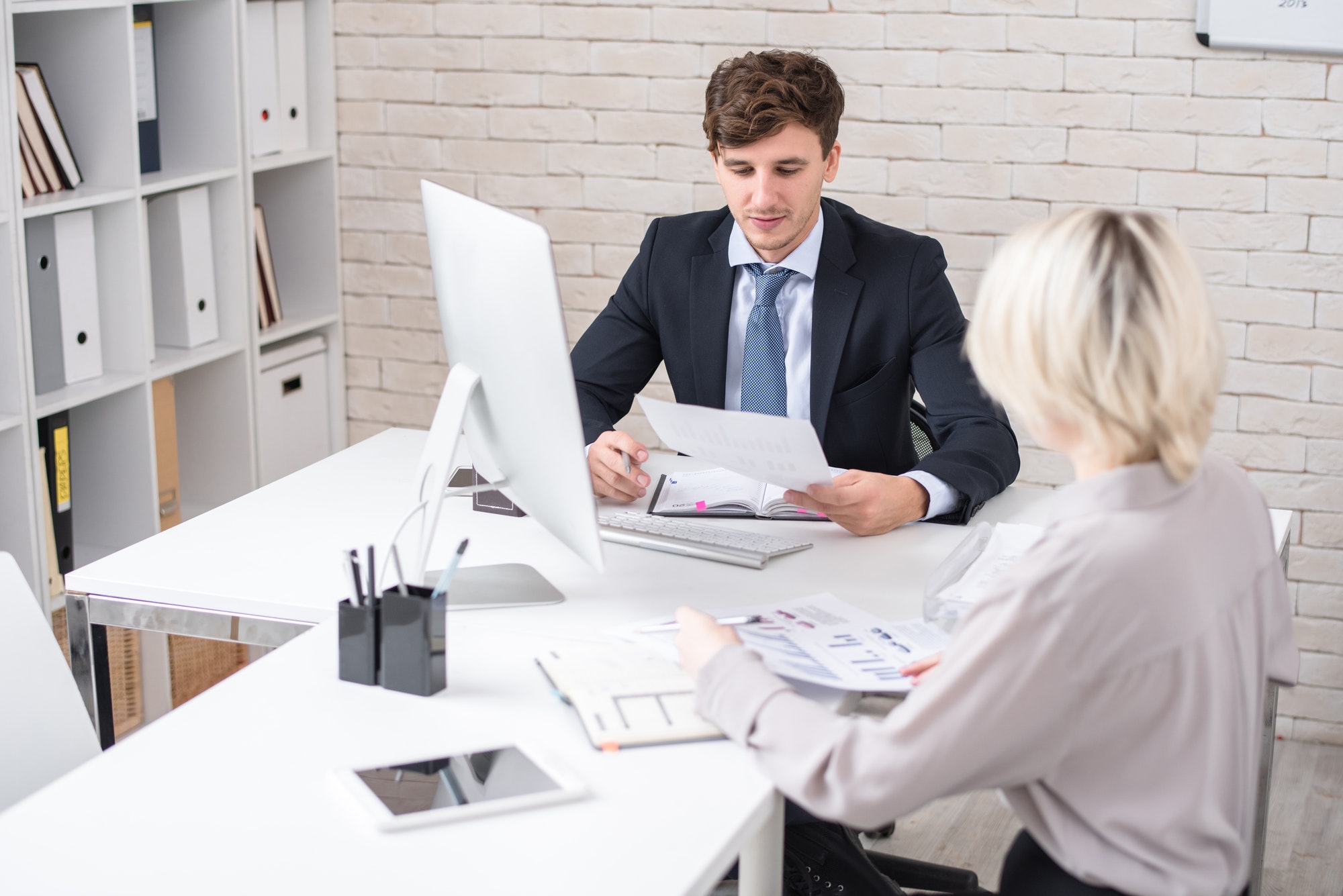Business People Discussing Statistics during Meeting in Office