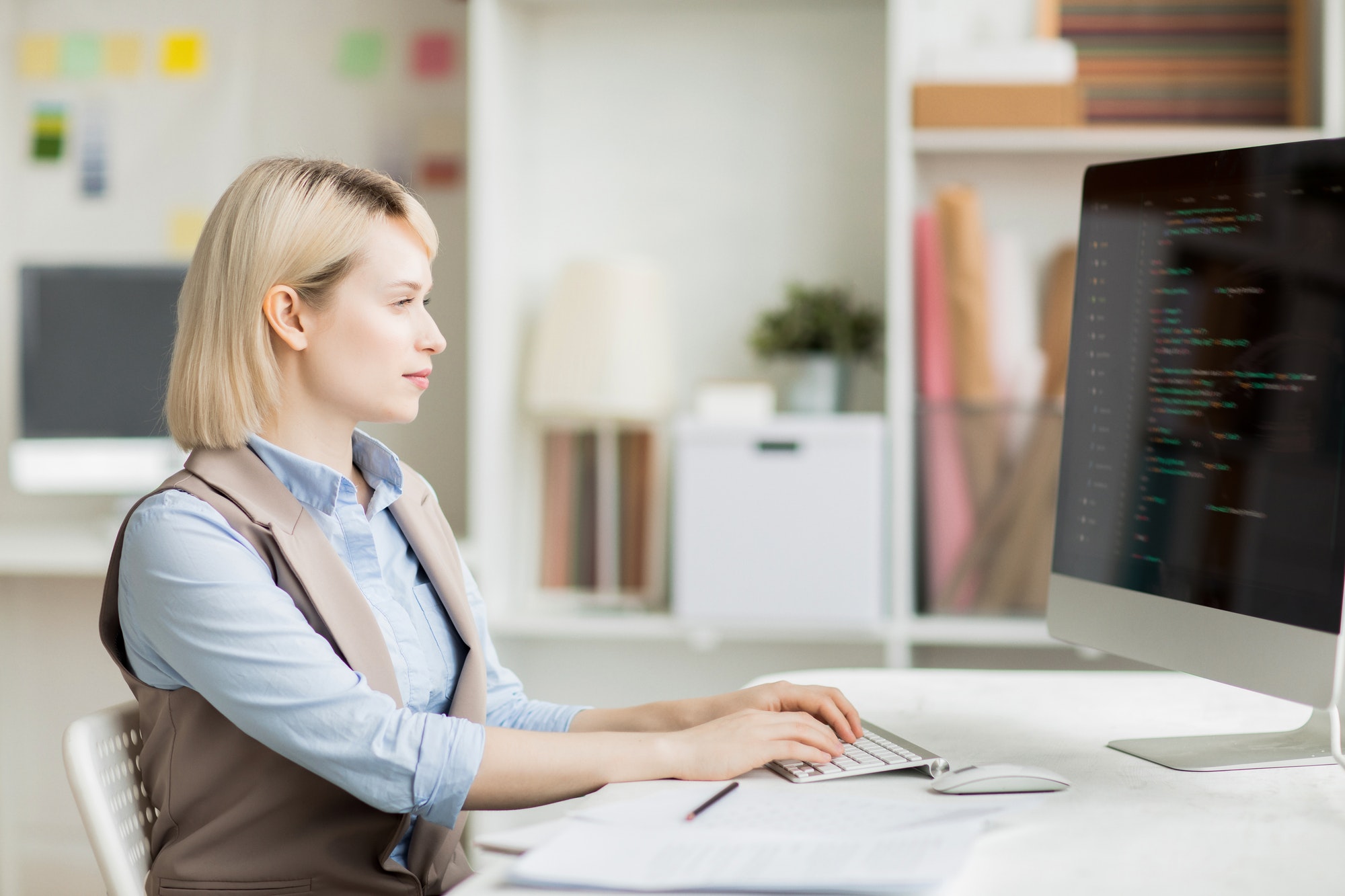 Busy lady composing code for software app