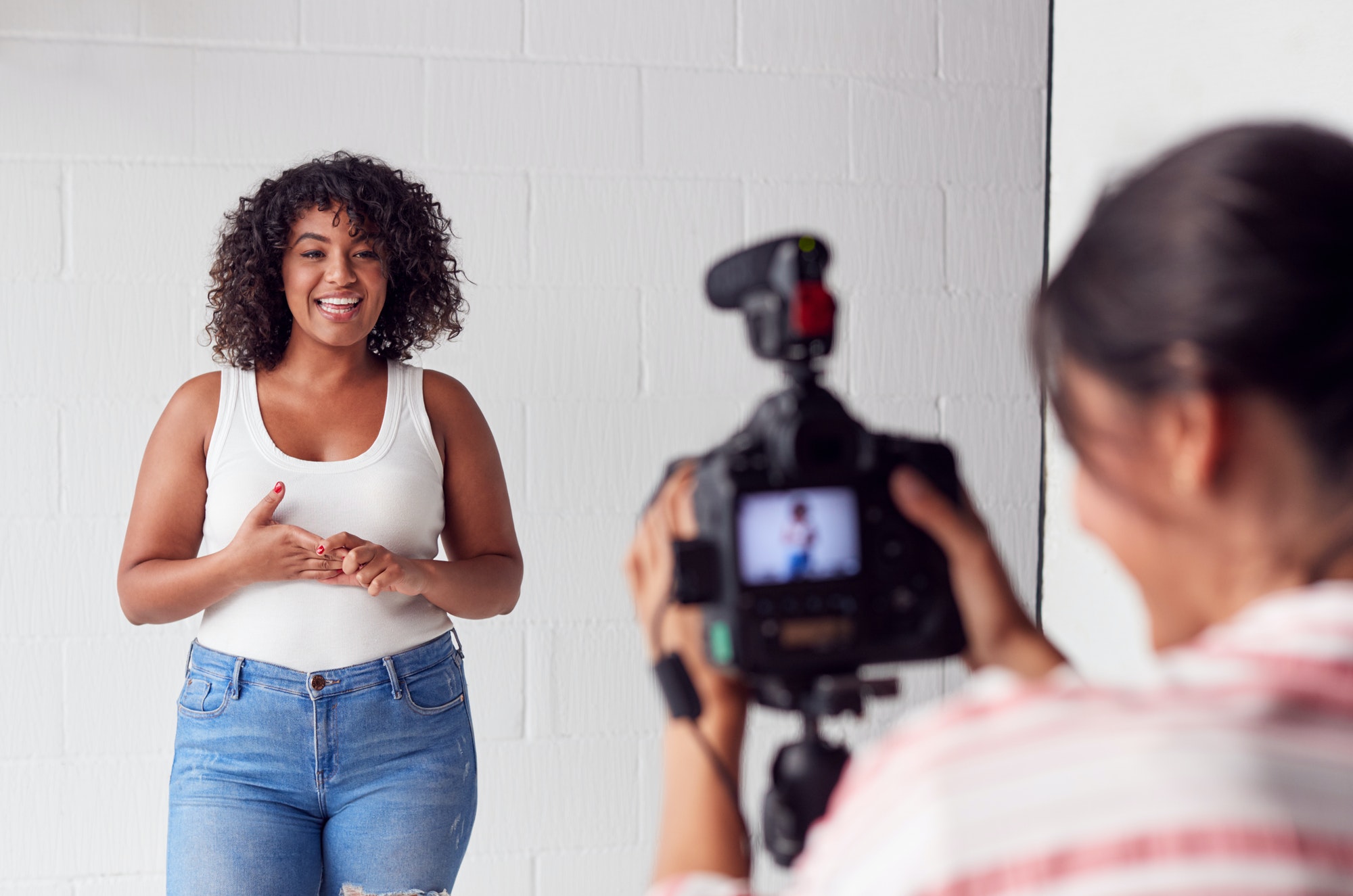 Female Videographer Recording Woman Recording Podcast In Studio